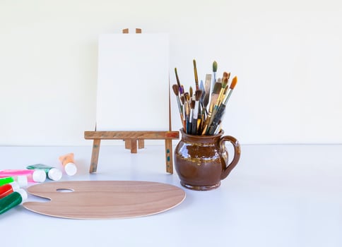 Artist's workplace. Canvas, paints, brushes and palette. photo