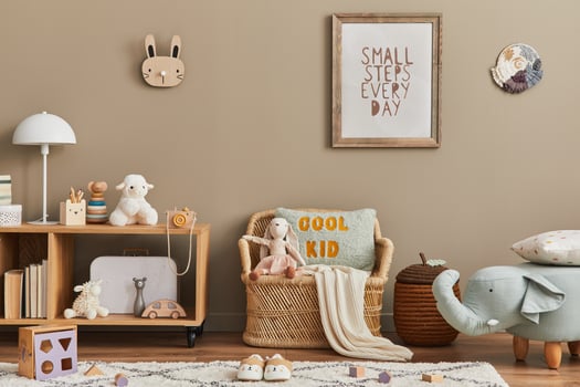Stylish scandinavian kid room interior with toys, teddy bear, plush animal toys, rattan sofa, furniture and child accessories. Brown wooden mock up poster frame on the wall. photo