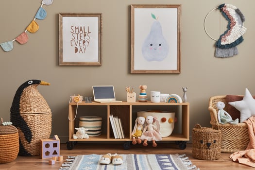 Stylish scandinavian kid room interior with toys, teddy bear, plush toys, mint armchair, furniture, decoration and child accessories. Brown wooden mock up poster frames on the wall. photo