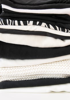 Stack of folded colorful clothes. Compact storage organizing photo