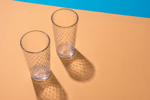 Empty transparent glass on a color background with copyspace. photo