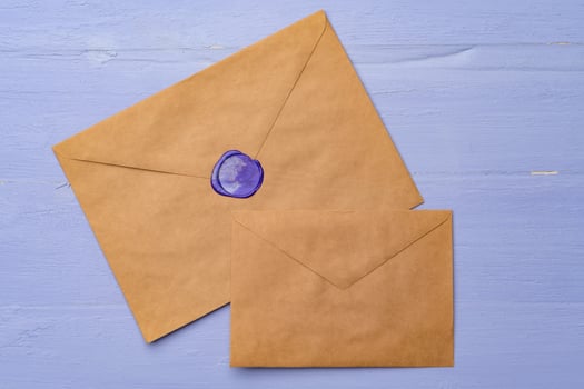 Letter envelope on lavender wooden background, copy space photo