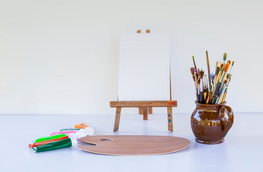 Artist's workplace. Canvas, paints, brushes and palette. photo