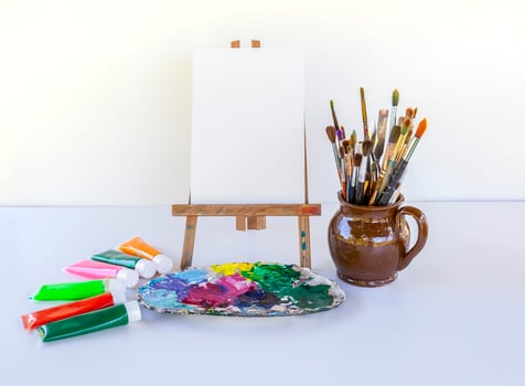 Artist's workplace. Canvas, paints, brushes and palette. photo