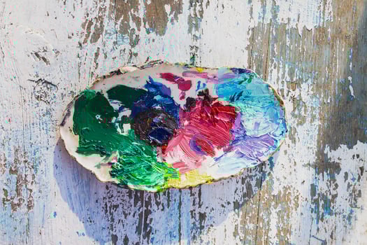 Dirty palette on shabby wooden background. photo