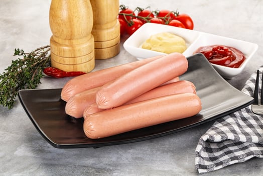 Boiled sausages with ketchup and mustard photo