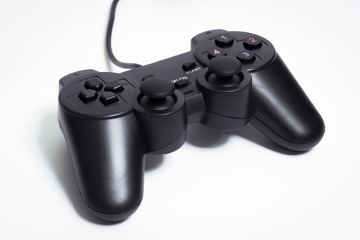 Black controller on white background, game device, Joystick on a white background. photo