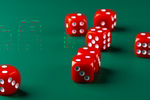 Red dice on green background close up photo
