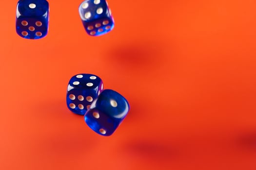 Blue dice on red background close up photo