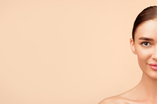 Portrait Of Attractive Young Woman Looking At Camera Posing Shirtless Standing Over Gray Background In Studio. Natural Female Beauty And Sensuality, Body Care Concept photo