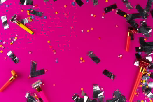 Silver sparkles tinsel on a pink background photo