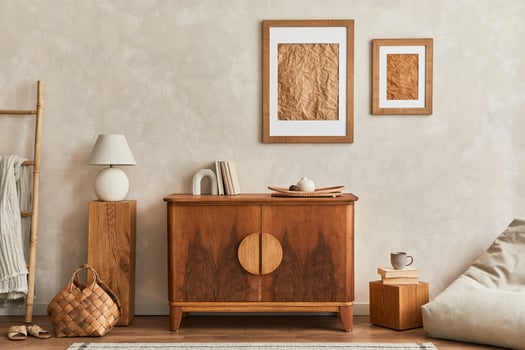 Interior design of living room with stylish retro commode, mock up poster frame, cube, table lamp, decoration and elegant personal accessories in home decor. Template. Japandi concept. photo