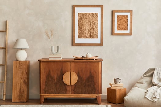Interior design of neutral living room with stylish retro commode, cube, table lamp, decoration and elegant personal accessories in home decor. Template. Japandi concept. photo