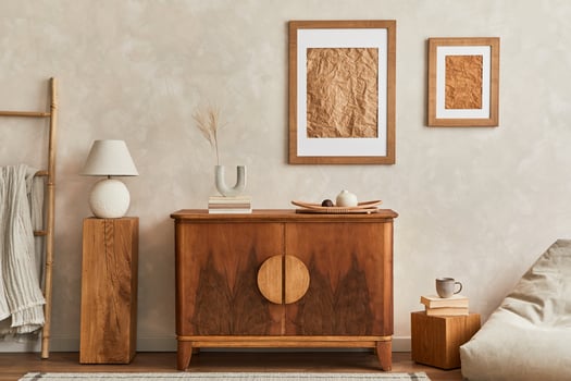 Interior design of neutral living room with stylish retro commode, mock up poster frame, cube, table lamp, decoration and elegant personal accessories in home decor. Japandi concept. photo