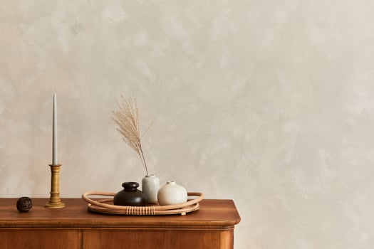 Minimalist composition of living room with commode, table lamp, dried flower in vase, book, decoration and elegant personal accessories in stylish home decor. Template. Copy space. photo