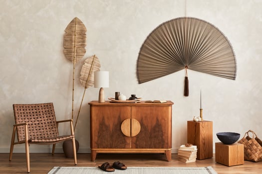 Minimalist composition of living room with wooden commode, table lamp, dried flower in vase, book, decoration and elegant personal accessories in stylish home decor. Template. photo