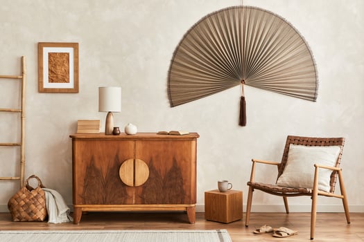 Interior design of neutral living room with stylish retro commode, mock up poster frame, cube, table lamp, decoration and elegant personal accessories in home decor. Template. concept. photo