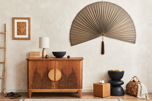 Interior design of living room with stylish retro commode, mock up poster frame, cube, table lamp, decoration and elegant personal accessories in home decor. Template. Japandi concept. photo