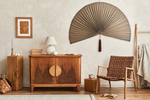Interior design of neutral living room with retro commode, mock up poster frame, cube, table lamp, decoration and elegant personal accessories in home decor. Template. Japandi concept. photo