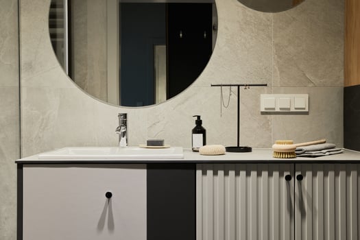 Stylish composition of modern bathroom. Designed shower, mixed wood commode, mirror and personal accessories. Walls with black and wooden panels. Minimalistic masculine concept. Template. photo