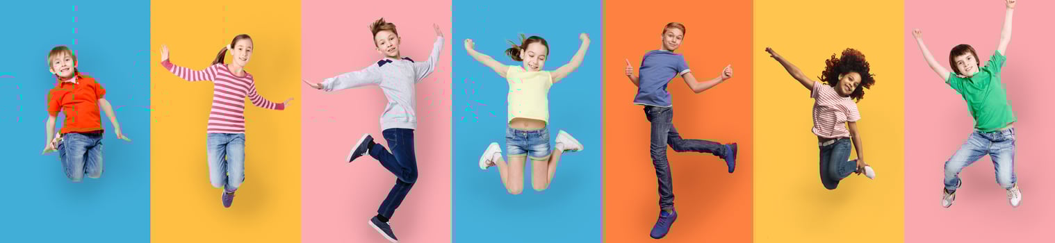 Happy Diverse Kids Jumping Posing Over Different Colorful Backgrounds. Collage With Joyful Multiracial Boys And Girls Jump Together. Carefree Childhood Concept. Panorama photo