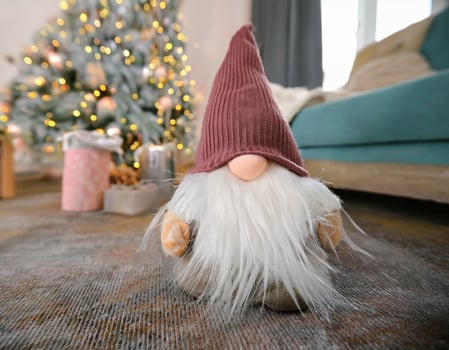 Christmas gnome under tree decorated, holiday lights background photo