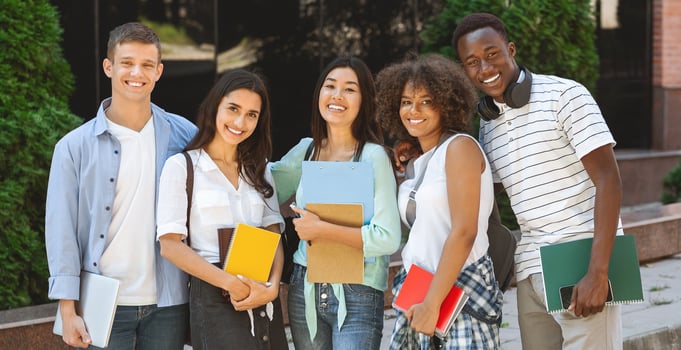 Portrait of happy international students posing outdoors near university building, smiling and embracing, taking group photo, panorama photo