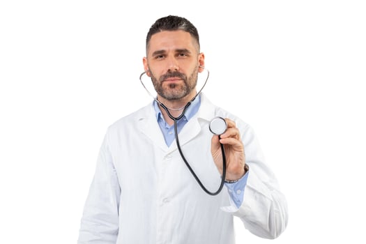 A man doctor, dressed in a white coat, holds a stethoscope against a plain white background. He appears focused, possibly preparing for a medical check-up or consultation. photo