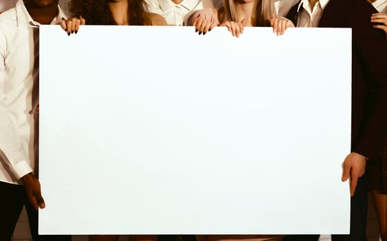 Unrecognizable Young People Holding Blank White Poster For Text Standing Indoor. Mockup, Cropped photo