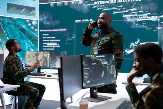 Group of soldiers in a high tech office environment collaborates on intelligence analysis, data processing and strategic planning. Maintaining national security and operational command service. photo