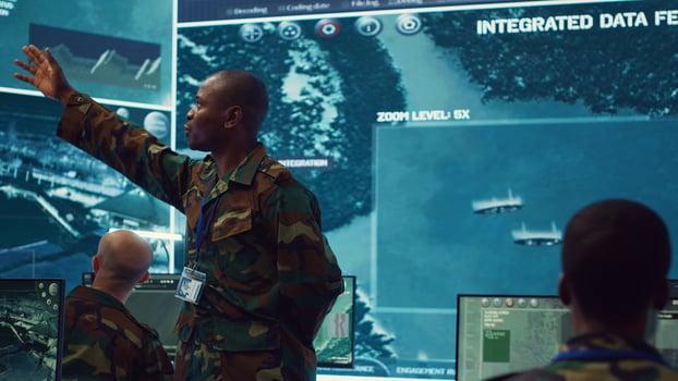 Major general updating and maintain the command center databases with current operational data, monitoring surveillance radar footage to ensure national safety. Control room. Camera A. photo