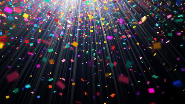 Colorful confetti suspended mid-air, with beams of light fanning out and illuminating the particles as they fall against a black void photo