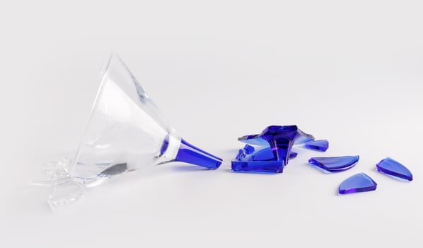 Broken wine glass on a white background. photo