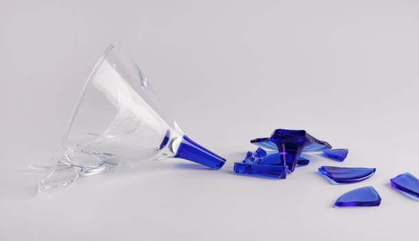 Broken wine glass on a white background. photo
