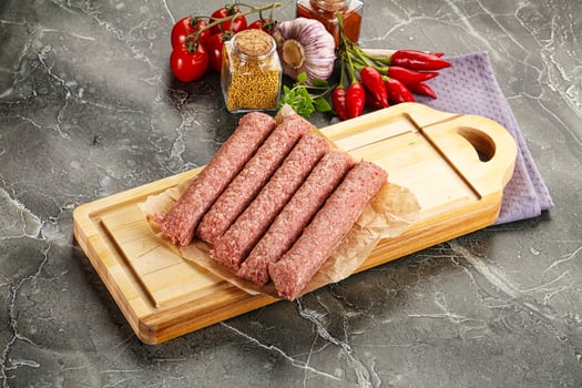 Raw beef kebab sausage for grill photo