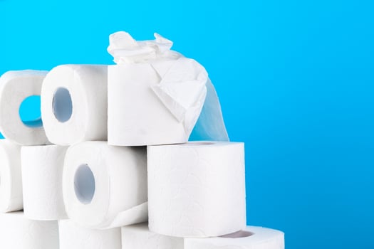 Toilet paper. Close up shot on blue background photo