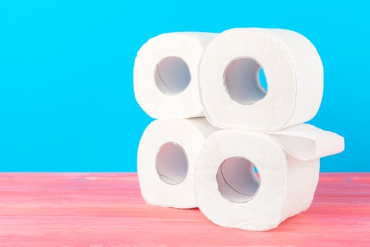 Toilet paper stack on bright blue background photo