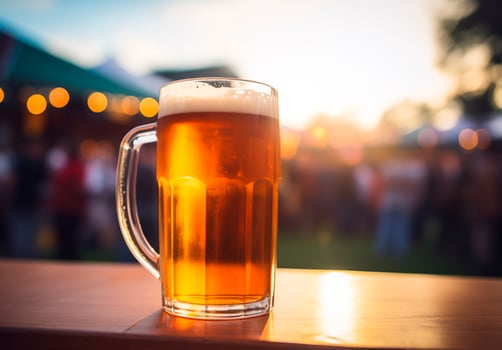 Beer glass on wooden table, music festival background photo