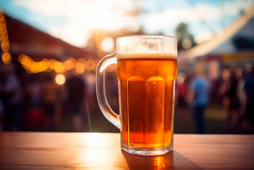 Beer glass on wooden table, music festival background photo