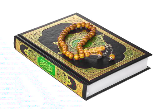 Islamic Book Holy Quran and beads on withe background photo
