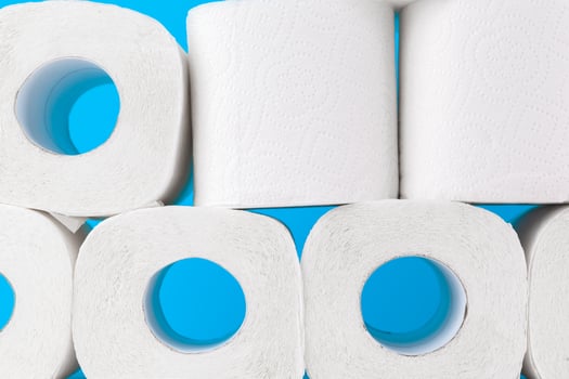 Toilet paper. Close up shot on blue background photo