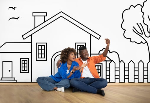 Loving black family husband and wife sitting over drawn on white wall house, holding key and smiling. Real estate, mortgage concept photo