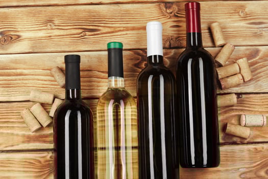 bottle of wine over wooden background photo