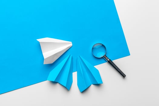 paper plane with office supplies on blue background photo