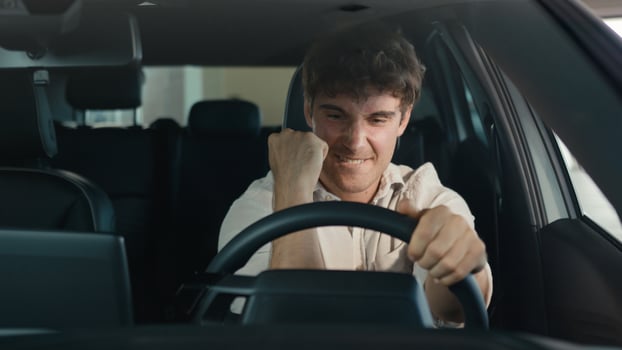 Smiling positive successful happy Caucasian man excited with new luxury car make winner hands gesture achieve triumph enjoy automobile buying male client buy vehicle transport celebrate sitting inside photo