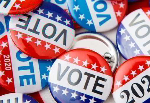 Red, white, and blue vote buttons on background with American flag, elections 2020 photo