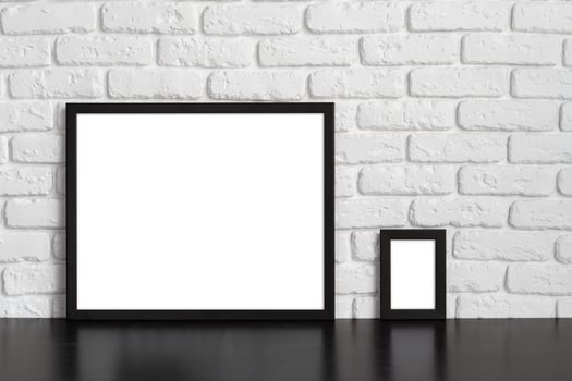 Blank picture frame against brick wall with copy space photo