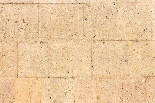 polished light brown tuff stone tiles on wall photo