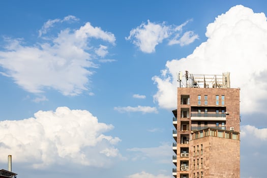white clouds in blue sky and towers urban house photo