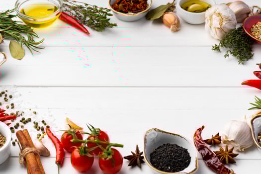 Olive oil and spices on kitchen table photo